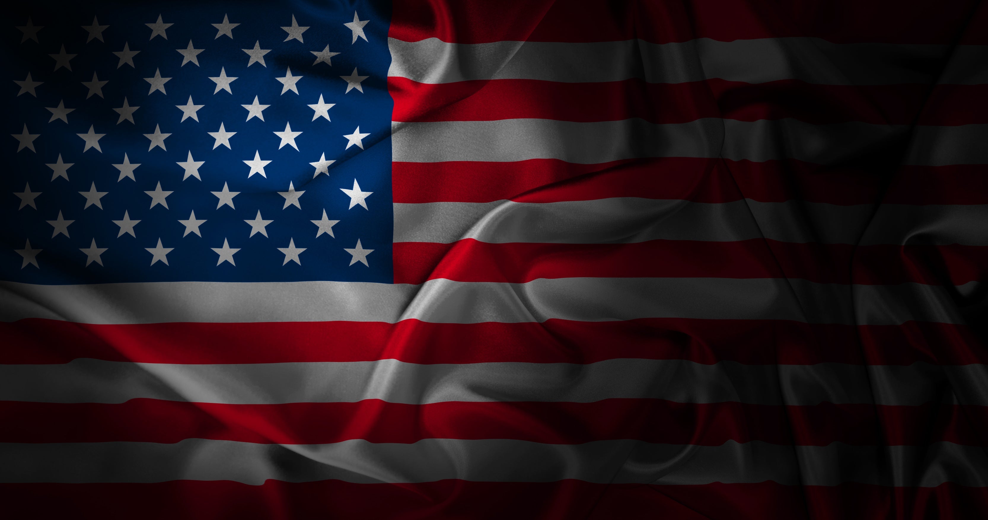 Waving American flag with a dark background