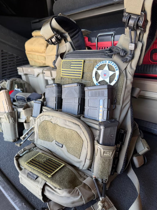Tactical backpack with various pouches and equipment inside a vehicle