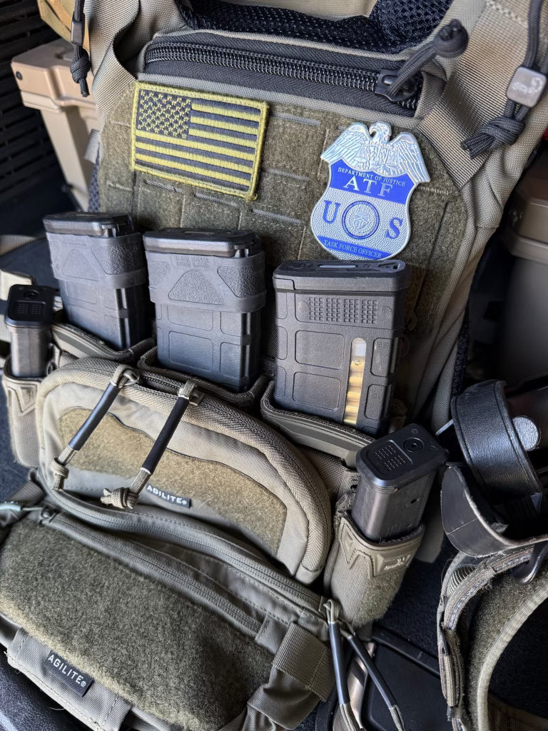 Tactical gear with ATF Flex Badge patch, ATF UOS badge, and multiple pouches.
