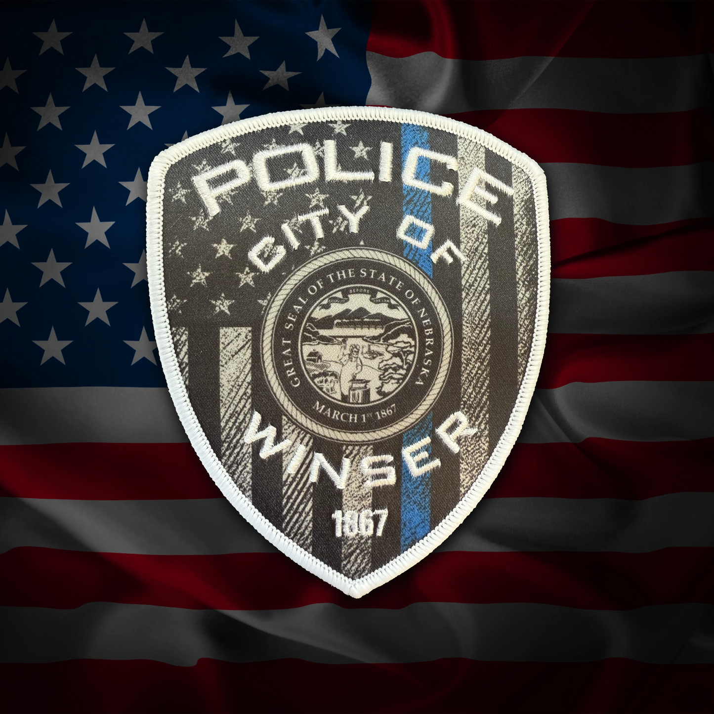 Police badge of the City of Winser on an American flag background
