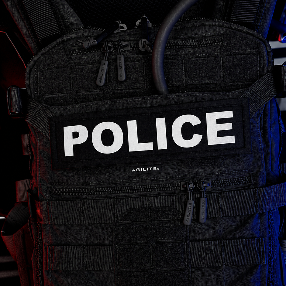 Black tactical vest with 'POLICE' text on a dark background