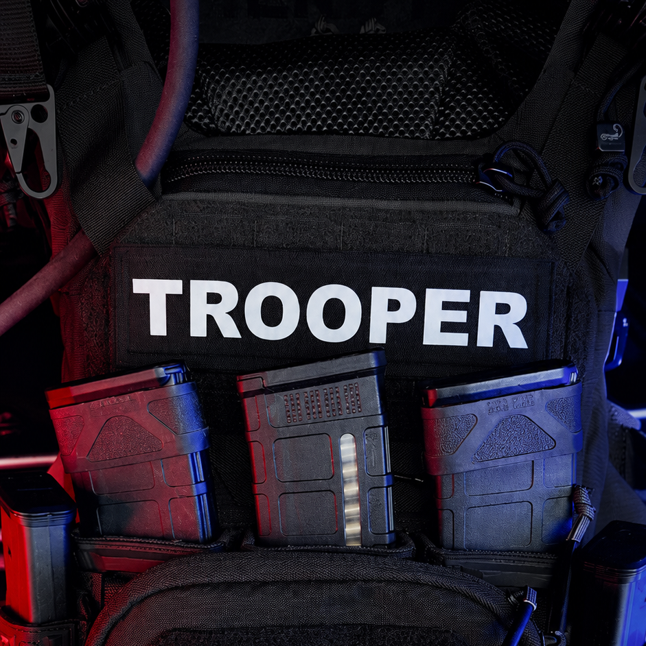 Backpack with 'Trooper' branding and visible Agilitix logo in a dark setting.