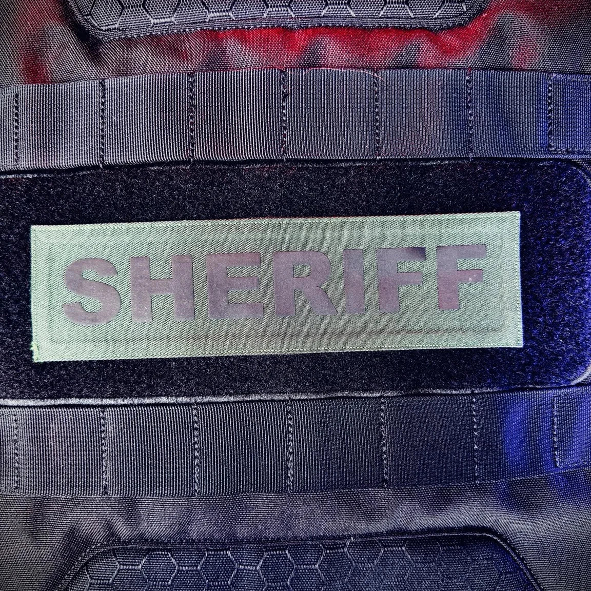 Patch with 'SHERIFF' text on a tactical vest