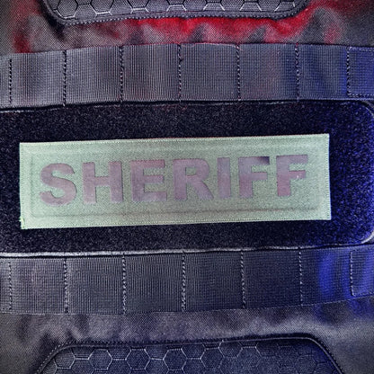 Patch with 'SHERIFF' text on a tactical vest