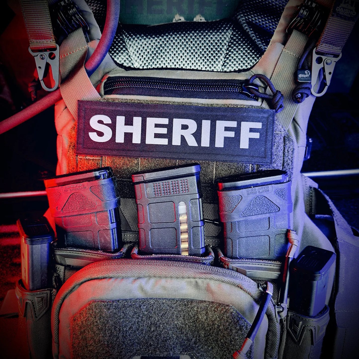 Pouch with 'SHERIFF' patch and various compartments in a tactical setup.