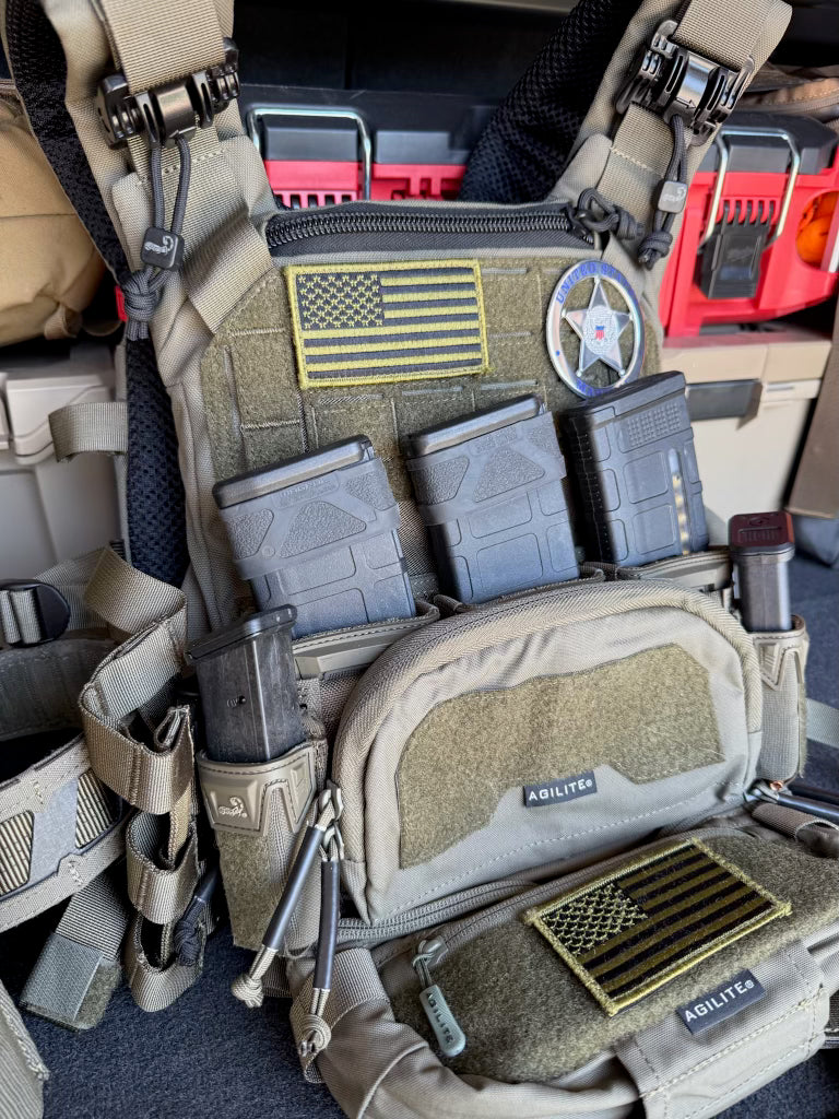 Close-up of tactical gear with American flag patch and 'AGILITE' branding.