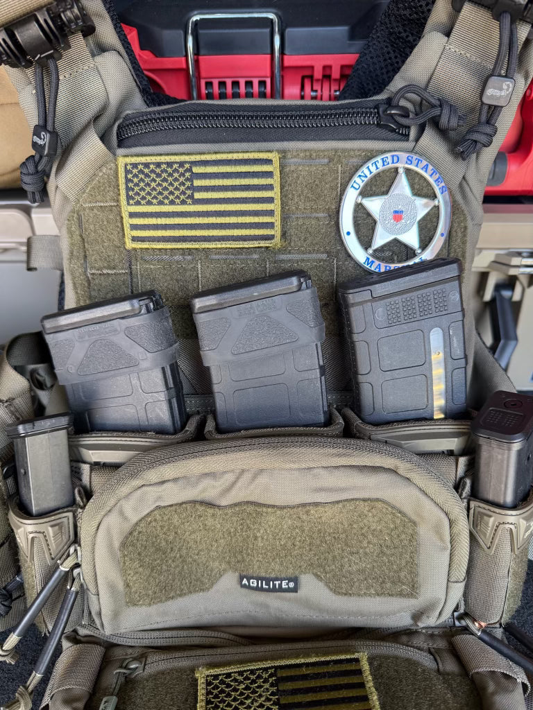Close-up of a tactical vest with American flag patch, U.S. Marshal Flex Badge
