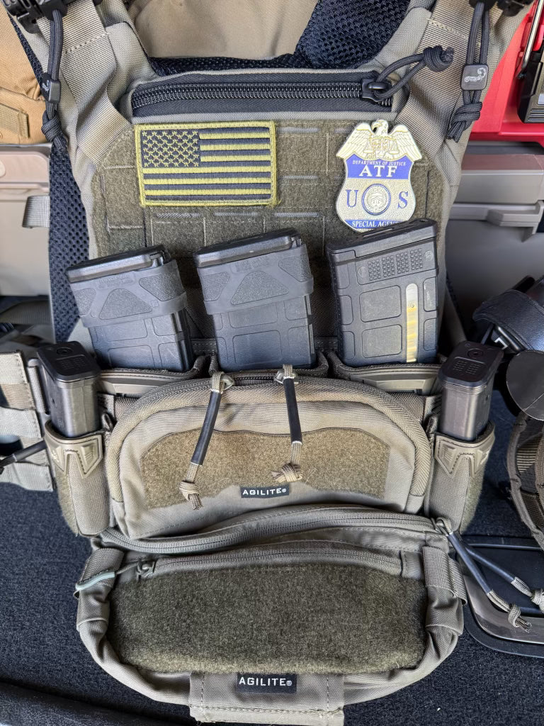  tactical vest with multiple pouches and patches including an American flag and ATF Flex Shield Badge