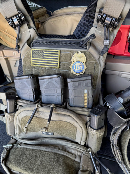 Tactical vest with DEA Flex Badge,  American flag patch, and U.S. emblem.