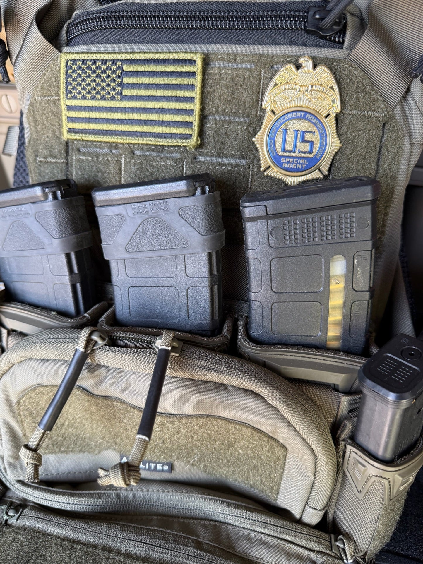 Tactical pouch with American flag patch, police flex badge, and magazines.