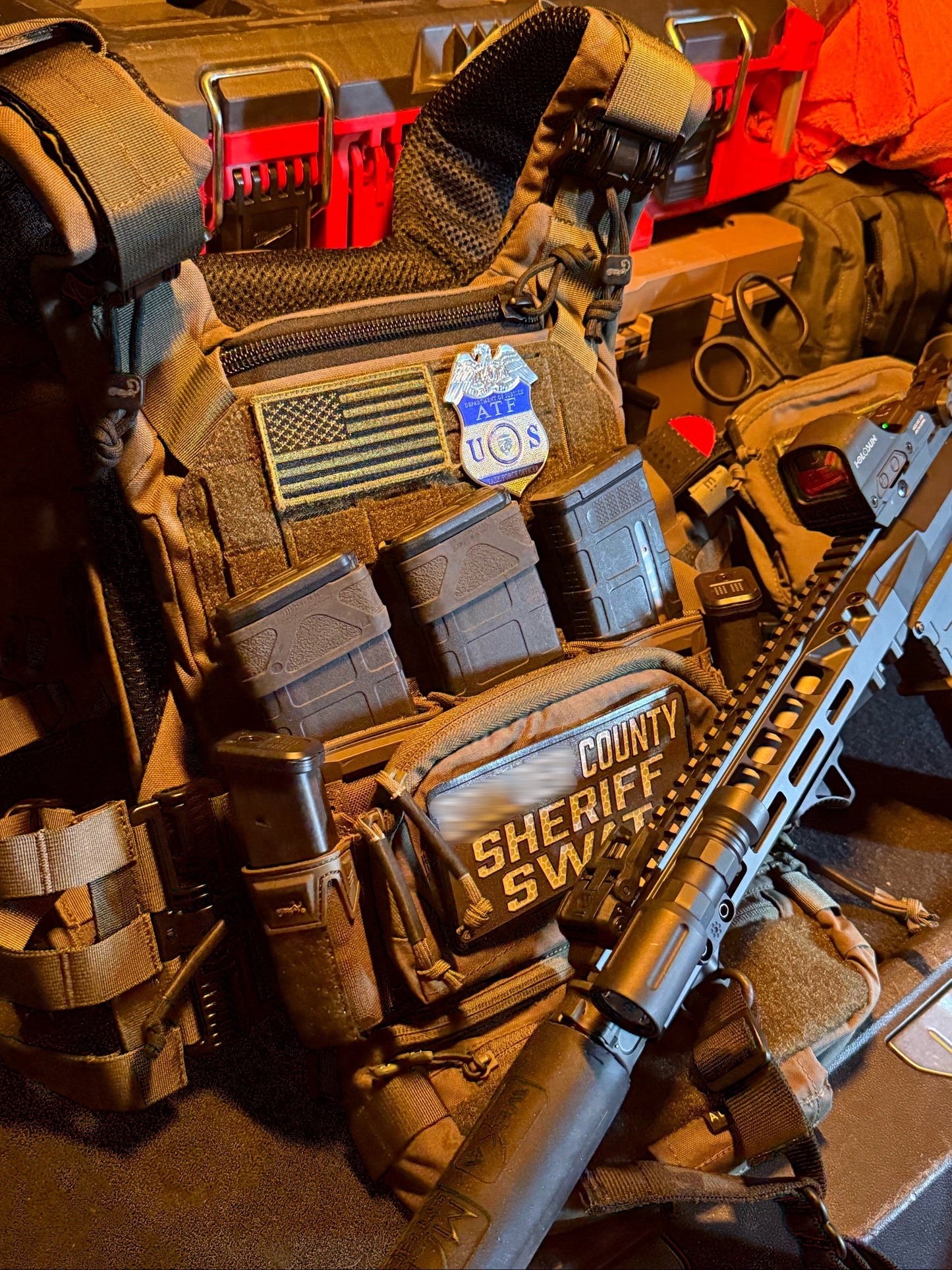 Tactical vest with an ATF TFO Flex badge and a  'County Sheriff SWAT' patch and a rifle