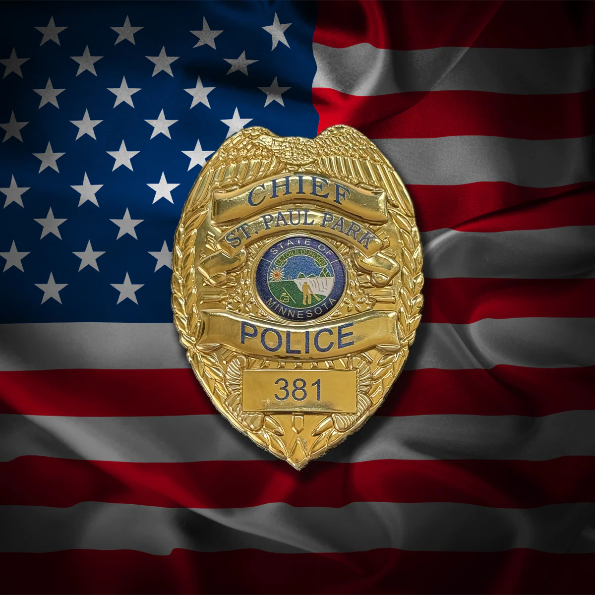 Gold police flex badge with 'Chief St. Paul Park Police' on an American flag background
