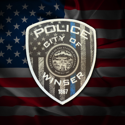 Police badge of the City of Winser on an American flag background
