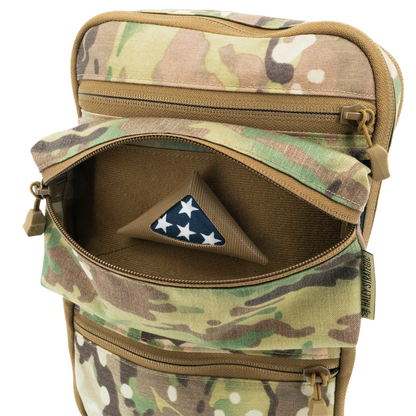 Camouflage bag with a pouch containing a small American flag on a white background