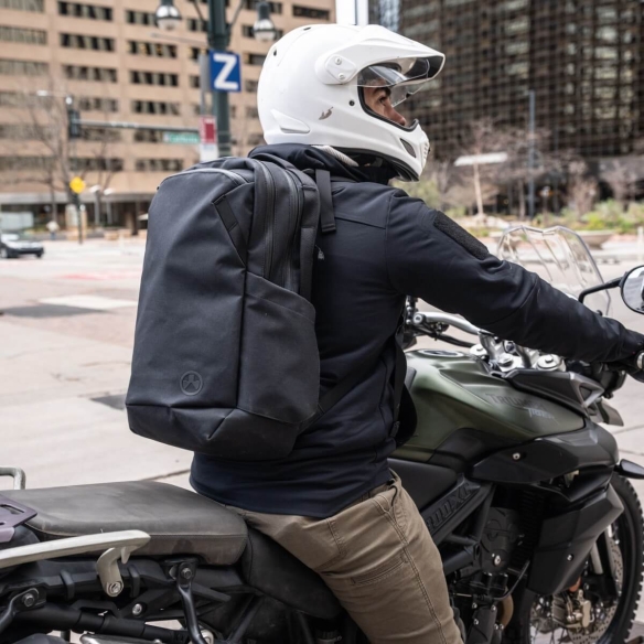 Motorcyclist wearing the Magpul EDC25 Backpack in black, demonstrating urban mobility and tactical carry capability